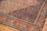 Antique Senneh rug's intricate navy Herati motif field and madder root red border detail.