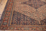 Early 20th century Persian Senneh rug corner, with madder root red border and navy Herati motifs.