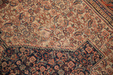Antique Persian Senneh rug: intricate Herati motif in ivory, madder red, navy, with worn pile.