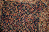 Intricate Herati motif in navy blue, madder root red, ivory on antique Senneh rug.
