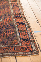 Geometric lattice, blossomed florals on the antique Belouch rug border in madder red, navy blue.
