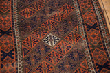Visible knot wear and geometric floral motifs in madder red and navy on antique Belouch rug.