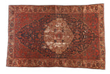 Antique Malayer rug, brick red and navy blue floral medallion field, visible foundation wear.