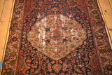Antique Malayer rug's roundel medallion and floral field showing extensive foundation wear.