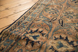 Antique Yazd runner detail: sand field, sky blue Safavid palmettes, and visible wear.