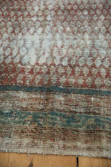 Distressed texture of a hand-knotted Malayer rug showing low pile and a sky blue border.