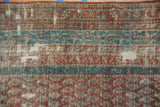 Worn knot heads and exposed cotton foundation on an antique distressed Persian Malayer runner.
