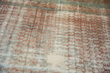 Storied texture of a distressed Malayer runner with worn-down knots and visible foundation.