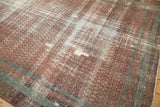 Angled detail of the antique Malayer's worn pile, showing exposed foundation and texture.