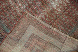 Detail showing the woven foundation and distressed boteh-patterned pile of an antique Malayer rug.