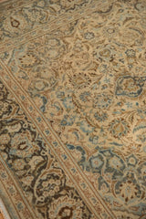 Distressed Kashan rug pile, showing ivory, dusty blue floral blossoms and faint foundation.