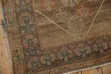Distressed Serab rug corner, featuring an abrashed brown field and rust, powder blue border.