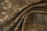 Distressed Serab runner's folded pile, showing coffee brown, blue, rust plant and border motifs.