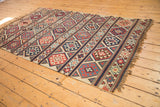 Antique Caucasian Shirvan Kilim corner, with banded geometric patterns, navy, brick red, and woven fire design.