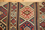 Geometric banded patterns and woven fire motifs on an antique Shirvan Kilim rug.