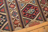 Antique Shirvan Kilim displaying woven fire design, geometric bands, navy, brick red, and beige.