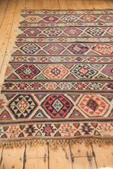 Shirvan Kilim's geometric fire motif border, brick red, beige, navy, with fringe.