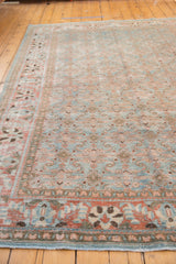Distressed sky blue and terra cotta Tabriz rug showing faded Herati motif.