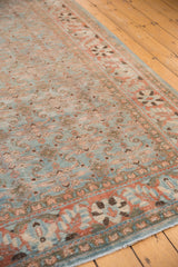 Worn sky blue and terra cotta Herati motifs with exposed foundation on a distressed Tabriz carpet.