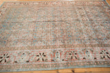 Distressed vintage Tabriz rug with faded sky blue Herati motif and brick orange border.