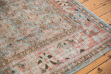 Distressed texture and faded sky blue, terra cotta Herati motifs on a vintage Tabriz carpet.