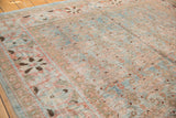 Distressed Tabriz carpet detail: sky blue and terra cotta Herati motif with even wear.