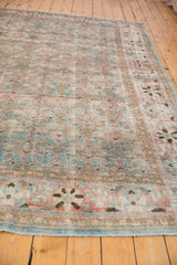 Corner detail of distressed Tabriz carpet, revealing sky blue, terra cotta Herati motif, even wear.