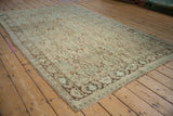 Distressed vintage Shiraz carpet corner, Herati motif, sea foam green, brown, and worn knot heads.