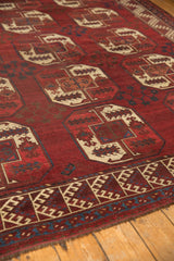 Vintage Ersari rug with cherry red elephant footprint medallions and geometric hook border.