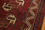 Cherry red Ersari carpet featuring ivory elephant footprint gul and a hook and latch border.