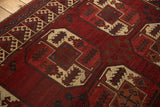 Vintage Ersari carpet detail: cherry red gul motifs, ivory geometry, blue hook and latch border.