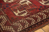 Detail of Ersari carpet's cherry red field, ivory hook and latch border, and elephant footprint motif.