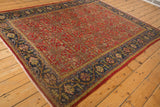 Navy border of Vintage Mahal carpet, showing meandering vine with germinating buds.