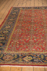 Vintage Mahal carpet border with navy blue, germinating floral motifs, and brick red Herati field.
