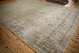 Distressed vintage Yazd carpet corner, worn floral palmettes, seafoam green, dusty rose.