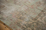 Distressed Yazd rug corner: sea foam green, dusty rose floral bouquets, palmettes.