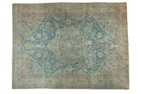 Distressed vintage Persian Tabriz carpet with faded blue medallion and intricate vinery.