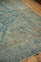 Distressed vintage Tabriz carpet revealing worn sky blue, ivory, and brown tones with exposed foundation.