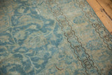 Distressed sky blue Tabriz pile, with antique ivory hues and chocolate brown geometric border.