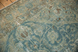 Distressed sky blue and antique ivory field with scrolling vinery on vintage Tabriz.