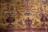 Close-up of gold Sarouk rug field, highlighting a cartouche, paisley motif, and wear.