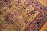 Vintage Sarouk rug corner: inscription cartouche, navy border, gold field, germinating motifs.