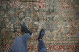 Distressed vintage Mahal carpet with celadon green field, allover palmette design, and visible pile wear.