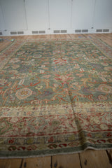 Distressed vintage Mahal carpet, celadon green field with red palmette and vinery details.