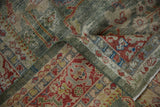 Distressed Mahal rug fold showcasing celadon green border and red palmette detail.