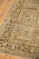 Vintage Tabriz rug's hand-knotted texture, chocolate brown cypress tree border, sand tones, and wear.