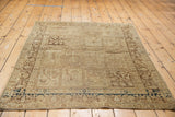 Vintage Tabriz rug corner, cypress tree border, dark blue detail, and worn pile.