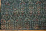 Distressed Malayer fragment, showing worn blue and red allover boteh pattern and secured edge.