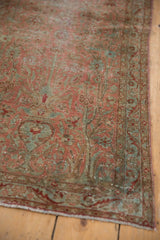 Distressed Yazd rug's European floral motifs, faint foundation, dusty rose and aqua hues.