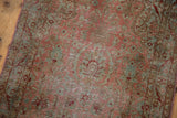 Distressed vintage Yazd rug displaying dusty blush floral bouquets and aqua European vine motifs.